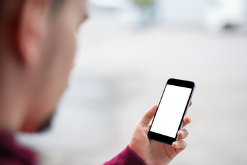 Man using mobile smartphone. - purple sweater, shot with third-person view, blank screen, mockup template