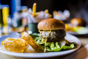 Hamburger with fresh vegetables and chips