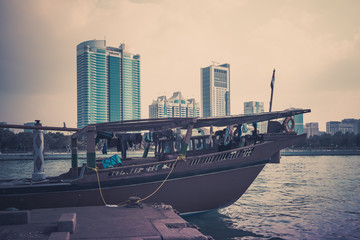 Abu Dhabi buildings skyline with old fishing boats