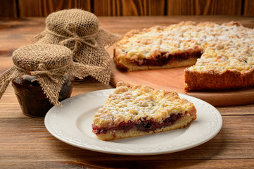 Cherry tart on wooden background.