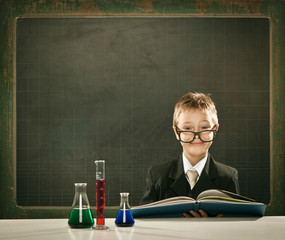 young elegant clever chemistry student or scientist serious pose with blackboard