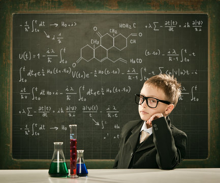 young elegant clever chemistry student or scientist serious pose with blackboard