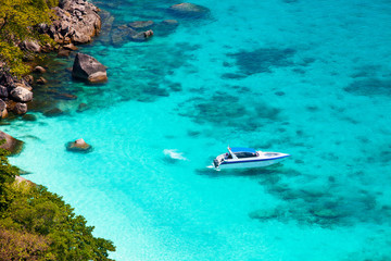 Fototapeta na wymiar Tropical sea and speed boat, standing near the shore