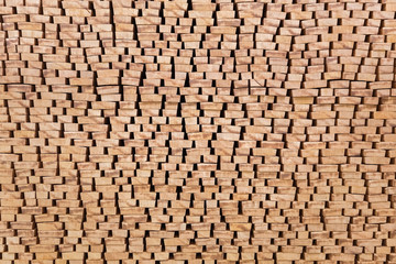 The ends of processed lumber stacked on the open air