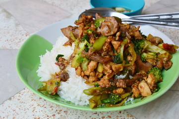 spicy stir-fried chicken innards with basil leaves on rice