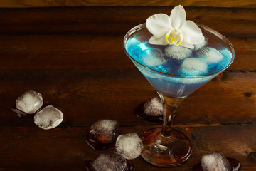 Cocktail Blue Martini on the dark wooden background