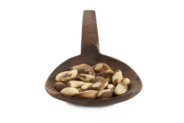peeled almonds nuts on a wooden spatula