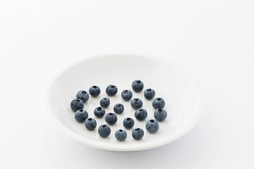 Fresh blueberries on a white plate