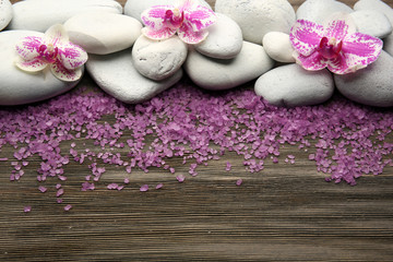 Obraz na płótnie Canvas Spa stones and orchid on wooden background