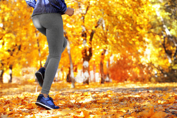 Runner legs outside during autumn day.