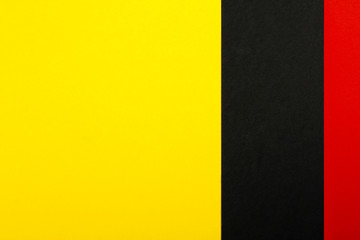 Color papers geometry flat composition background with yellow red and black tones