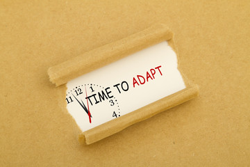 TIME TO ADAPT message written under torn paper.