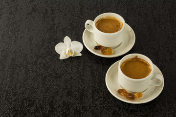 Two white cups of strong morning  coffee