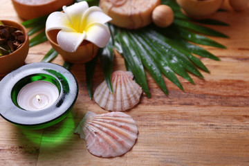 Beautiful spa setting on palm leaf on wooden table