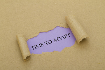 TIME TO ADAPT message written under torn paper.