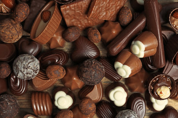 Assortment of delicious chocolate candies background, close up