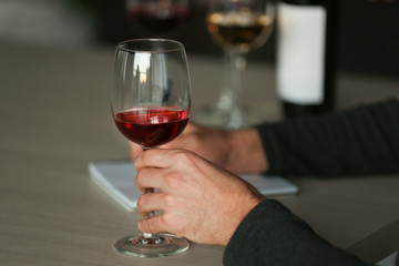 Man tasting new sorts of wine at the table