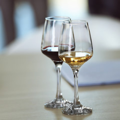 Two glasses of different wine on a table. Tasting wine concept