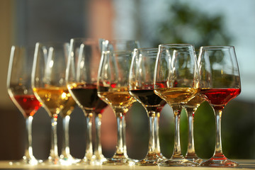 Many glasses of different wine in a row