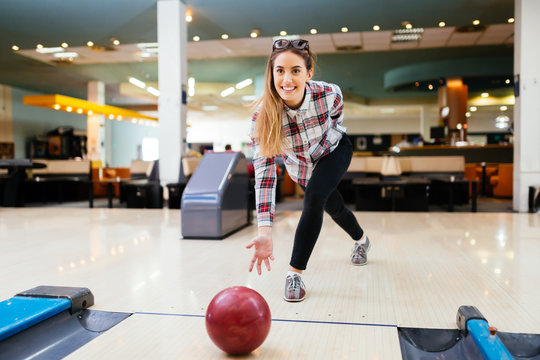 Woman throwing bowling ball