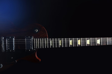 Obraz na płótnie Canvas Brown electric guitar on dark background
