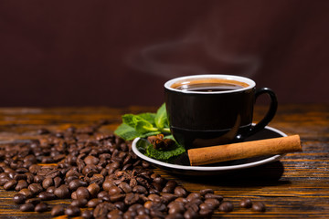 Cup of Hot Coffee with Cinnamon Stick and Beans