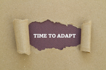 TIME TO ADAPT message written under torn paper.