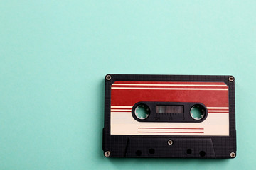Obraz premium Old audio cassette on turquoise background