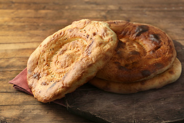 Flat bread on napkin on wooden background
