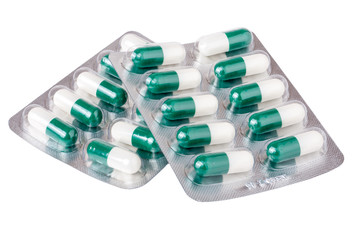 two packages with red green yellow pills on white background