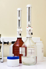 Bottles with top dispenser in biochemical laboratory