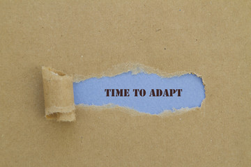 TIME TO ADAPT message written under torn paper.