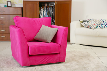 Pink armchair in modern interior of living room