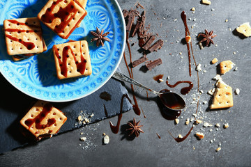 Tasty cookies with chocolate on dark background, close up