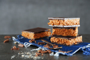 Tasty homemade cakes with chocolate on dark background, close up