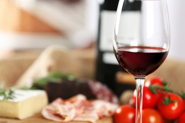 Glass of wine with food on table closeup