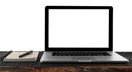 Laptop with notepad on wooden table against white background