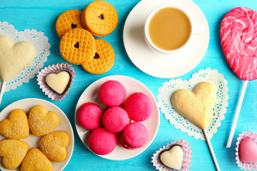 Valentine concept. Composition of cookies and candies on blue background