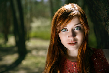 Fototapeta premium The young girl in a red dress
