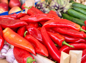 Fruit market with various fruits and vegetables. Fresh vegetables and fruits at a market stall. Colorful vegetable and fruits in a row with copy space. Pointed pepper in the foreground. 