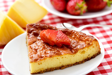 piece of homemade cheesecake on a set table