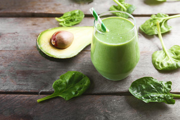 Fresh avocado smoothie on wooden background