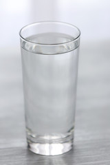 Glass of water on wooden background