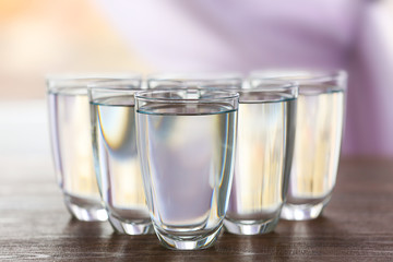 Glass of fresh water on wooden table