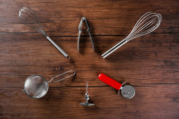 Set of kitchen stainless tools on wooden table