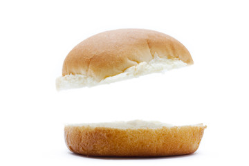 close-up view of burger bun in mid air.