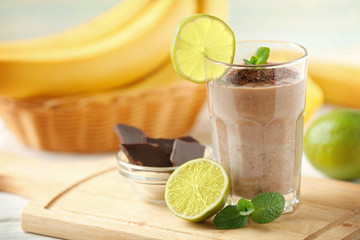 Fresh banana cocktail with chocolate and fruits on cutting board