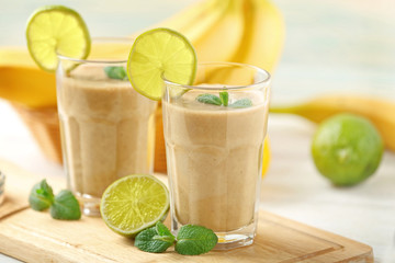 Fresh banana cocktail with fruits on cutting board