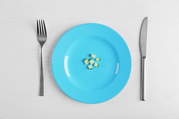 Pieces of cucumber in a blue plate on white table.. Top view.