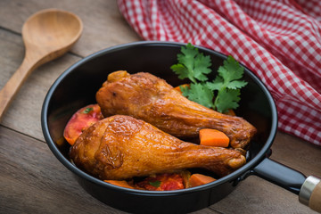 Grilled chicken legs and vegetables in pan
